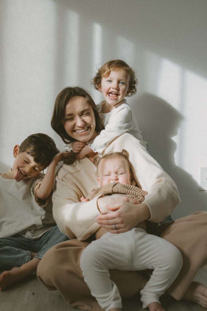Mother and her children being cuddly and playful during a studio photogrpahy session