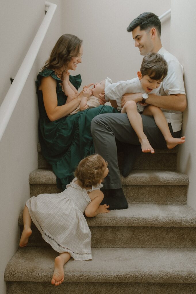 Family playing together in their home in Bremerton, Washington while being photographed by heather lewis portraits.