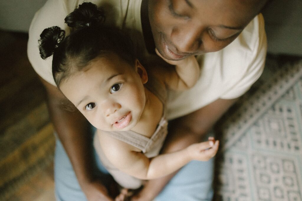 A black father and his daughter during an in-home family photo session